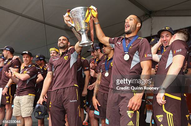 Shaun Burgoyne and Josh Gibson of the Hawks hold up the Premeirship Cup to the crowd at the Hawthorn Hawks AFL team celebration at Glenferrie Oval on...