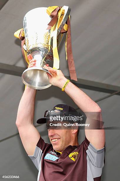 Alastair Clarkson the coach of the Hawks shows the Premeirship Cup to the crowd at the Hawthorn Hawks AFL team celebration at Glenferrie Oval on...