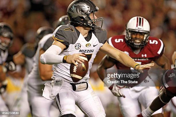 Missouri quarterback Maty Mauk eludes the South Carolina defense as he looks downfield in the second half at Williams-Brice Stadium in Columbia,...