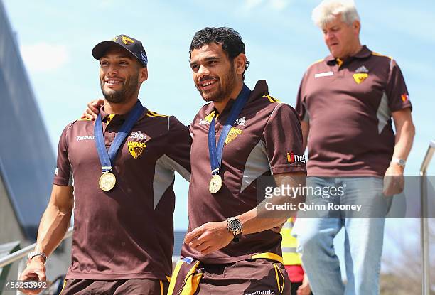 Josh Gibson and Cyril Rioli of the Hawks arrive for the Hawthorn Hawks AFL team celebration at Glenferrie Oval on September 28, 2014 in Melbourne,...