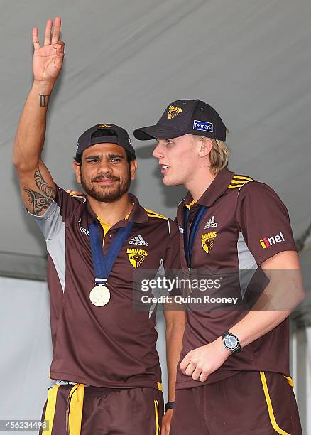 Cyril Rioli and Will Langford of the Hawks acknowledge the crowd at the Hawthorn Hawks AFL team celebration at Glenferrie Oval on September 28, 2014...
