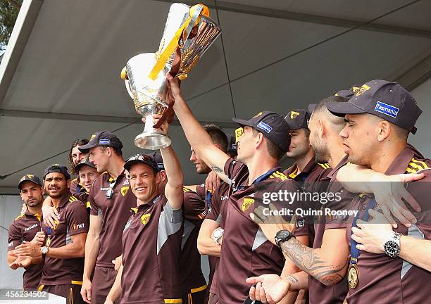 Alastair Clarkson the coach and Luke Hodge the captain of the Hawks hold up the 2013 and 2014 Premeirship Cups at the Hawthorn Hawks AFL team...