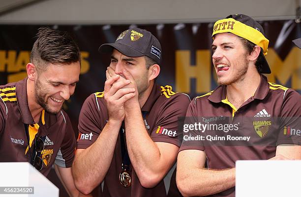 Jack Gunston, Brian Lake and Isaac Smith of the Hawks have a laugh at the Hawthorn Hawks AFL team celebration at Glenferrie Oval on September 28,...