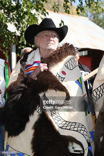 Willie Nelson is honored during a ceremony where he and Neil Young were presented with decorated buffalo hides before the Harvest The Hope Concert in...