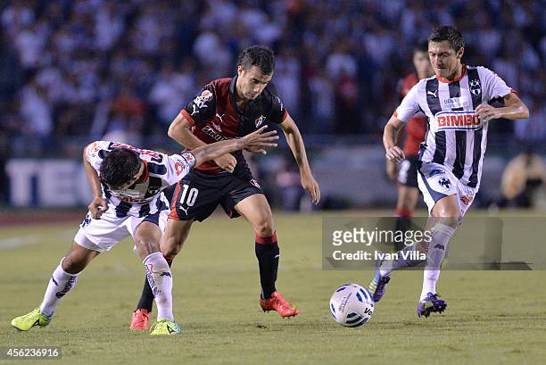 Severo Meza of Monterrey competes for the ball with Maicon Leite and Nery Cardozo of Atlas during a match between Monterrey and Atlas as part of 10th...