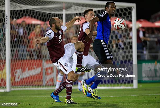 Atiba Harris of San Jose Earthquakes battles for control of the ball with Nick LaBrocca of Colorado Rapids as Shane O'Neill of Colorado Rapids...