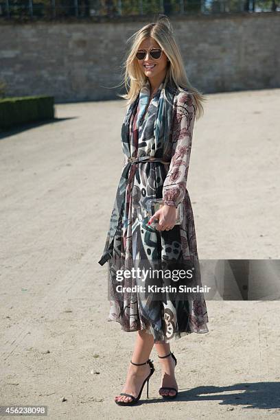 Blogger and Founder of La Rouge Lala Rudge is wearing a Chanel bag, Dior sunglasses and Burberry dress, belt and scarf on day 4 of Paris Collections:...