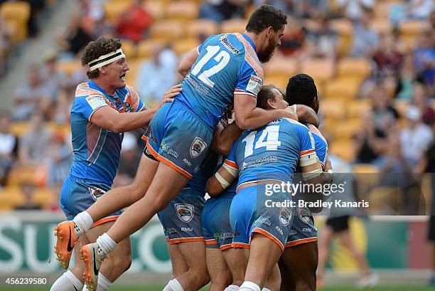 David Crampton of the Pride is congratulated by team mates after scoring a try during the Intrust Super Cup Grand Final match between Northern Pride...