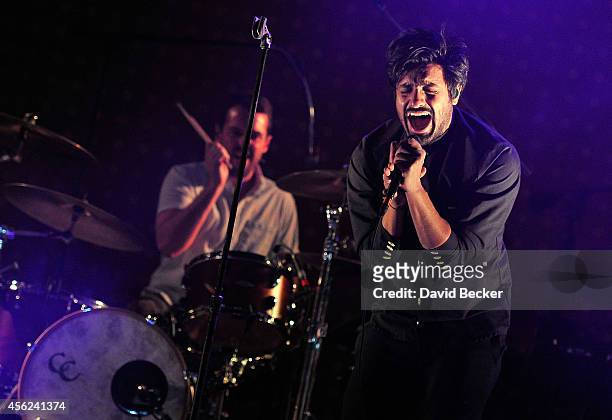 Drummer Francois Comtois and singer Sameer Gadhia of Young the Giant perform as the band opens for Kings of Leon during the Mechanical Bull tour at...