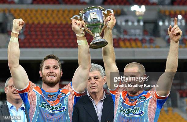 Brett Anderson and Jason Roos hold up the winners trophy after the Intrust Super Cup Grand Final match between Northern Pride and Easts Tigers at...