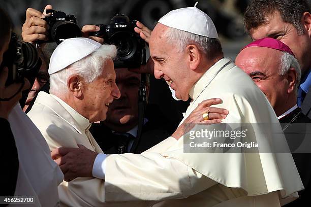 Pope Francis greets Pope Emeritus Benedict XVI as he arrives at St. Peter's Basilica during a celebration for grandparents and the elderly on...