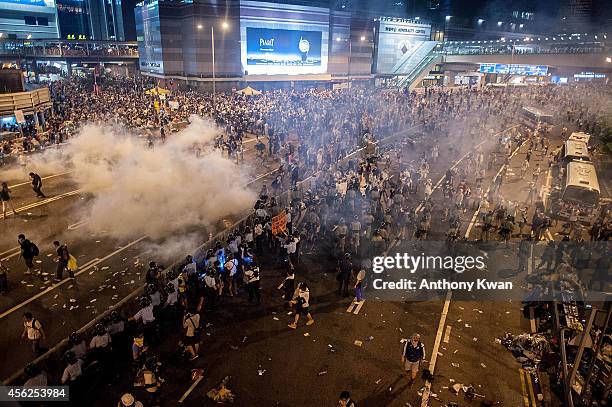 Demonstrators disperse as tear gas is fired by police during a protest on September 28, 2014 in Hong Kong. Thousands of people kicked off Occupy...