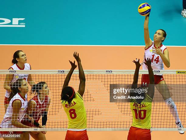 Meliha Ismailoglu of Turkey in action against Mballa and Bikatal of Cameroon during the 2014 FIVB Volleyball Women's World Championship Group B...