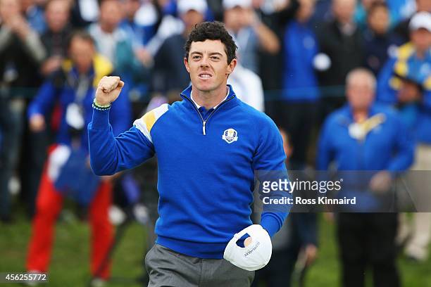 Rory McIlroy of Europe celebrates victory on the 14th hole during the Singles Matches of the 2014 Ryder Cup on the PGA Centenary course at the...