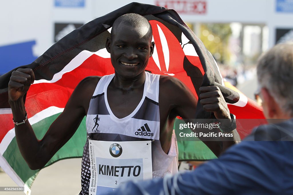 Dennis Kimetto, a 30-year-old Kenyan wins and proudly holds...