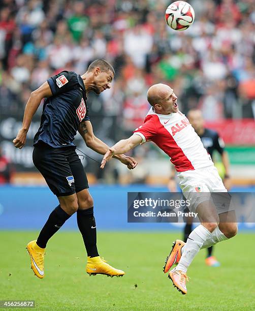 Marcel Ndjeng of Hertha fouls Tobias Werner of Augsburg during the Bundesliga match between FC Augsburg and Hertha BSC at SGL Arena on September 28,...