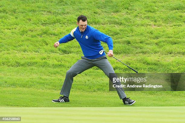 Martin Kaymer of Europe celebrates chipping in on the 16th hole to defeat Bubba Watson of the United States during the Singles Matches of the 2014...