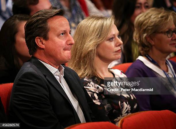 Prime Minister David Cameron sits with Ffion Hague as her husband, Leader of the House of Commons William Hague, addresses the Conservative party...