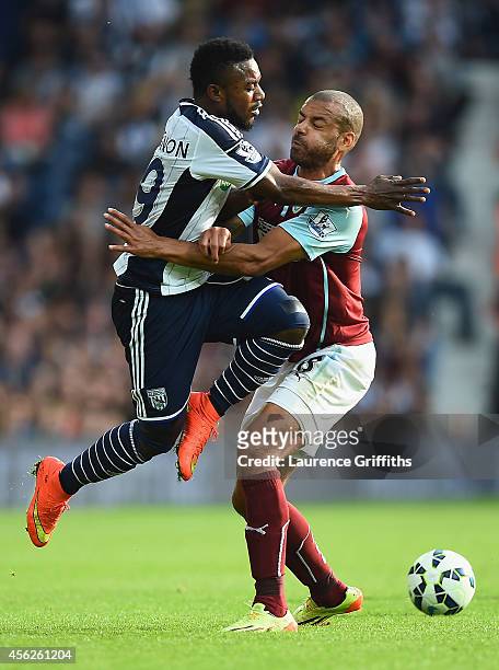Stephane Sessegnon of West Brom collides with Steven Reid of Burnley during the Barclays Premier League match between West Bromwich Albion and...