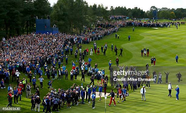 Jamie Donaldson of Europe shakes hands with Keegan Bradley of the United States on the 15th hole as Europe win the Ryder Cup during the Singles...