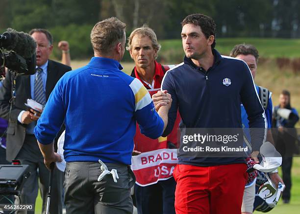 Jamie Donaldson of Europe shakes hands with Keegan Bradley of the United States on the 15th hole as Europe win the Ryder Cup during the Singles...