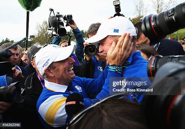 Jamie Donaldson of Europe and Europe team captain Paul McGinley celebrate on the 15th hole after Europe won the Ryder Cup with Donaldson defeating...