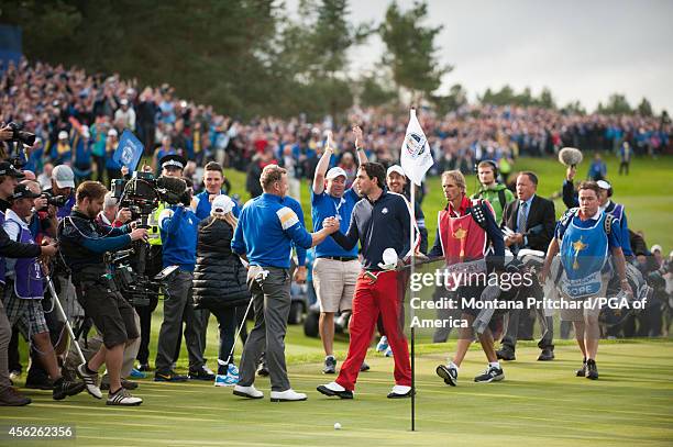 Jamie Donaldson of Wales and Keegan Bradley of the United States shake hands after their match during the singles matches for the 40th Ryder Cup at...