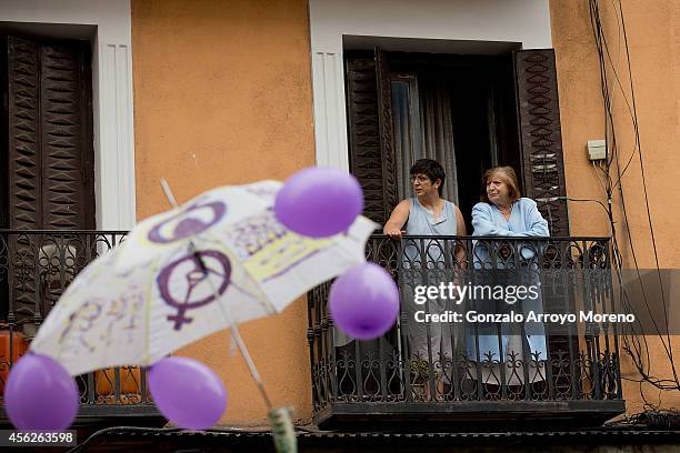 Two women watch from a balcony a demonstration supporting reproductive rights for women on September 28, 2014 in Madrid, Spain. During an...