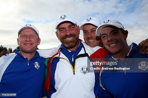 Jamie Donaldson, Thomas Bjorn, Henrik Stenson and Rory McIlroy of Europe celebrate winning the Ryder Cup after Donaldson defeated Keegan Bradley of...