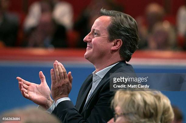 Prime Minister David Cameron listens to Leader of the House of Commons, William Hague, address delegates at the Conservative party conference for the...