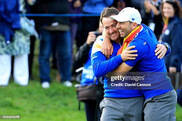 Graeme McDowell and Sergio Garcia of Europe celebrate winning the Ryder Cup after Jamie Donaldson of Europe defeated Keegan Bradley of the United...