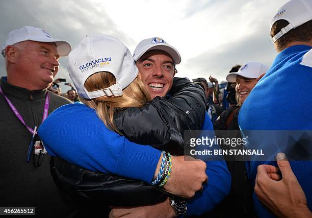 Rory McIlroy of Northern Ireland celebrates after teammate Jamie Donaldson of Wales retained the Ryder Cup for Team Europe during Sunday's Singles...