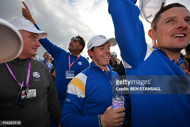 Rory McIlroy of Northern Ireland and Justin Rose of England celebrate after teammate Jamie Donaldson of Wales retained the Ryder Cup for Team Europe...
