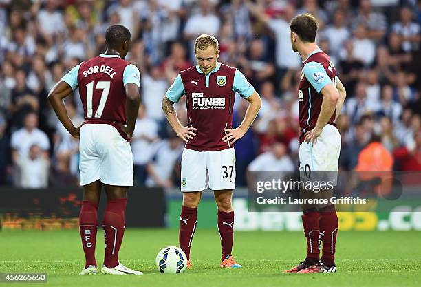Marvin Sordell, Scott Arfield and Ashley Barnes of Burnley show their dejection after conceding a goal during the Barclays Premier League match...