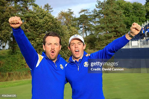 Graeme McDowell and Rory McIlroy of Europe celebrate winning the Ryder Cup after Jamie Donaldson of Europe defeated Keegan Bradley of the United...