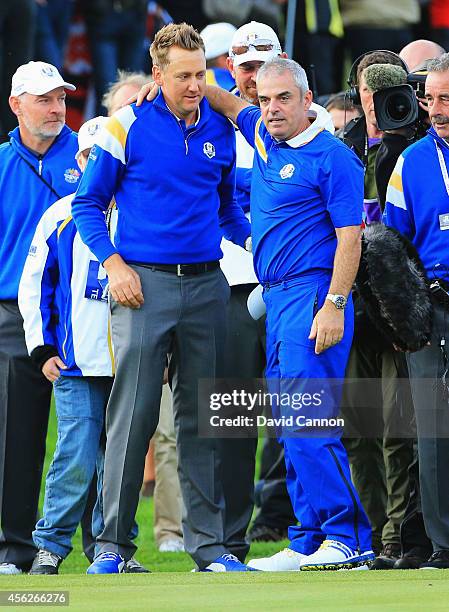 Ian Poulter of Europe celebrates with Europe team captain Paul McGinley after Europe won the Ryder Cup with Jamie Donaldson's victory against Keegan...