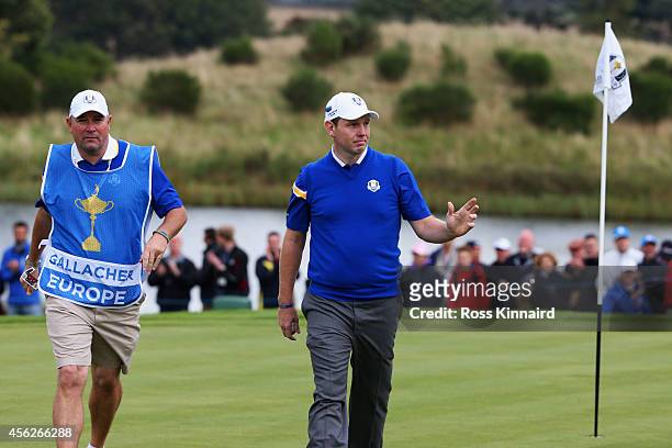 Stephen Gallacher of Europe walks off the green alongside caddie Damian Moore during the Singles Matches of the 2014 Ryder Cup on the PGA Centenary...
