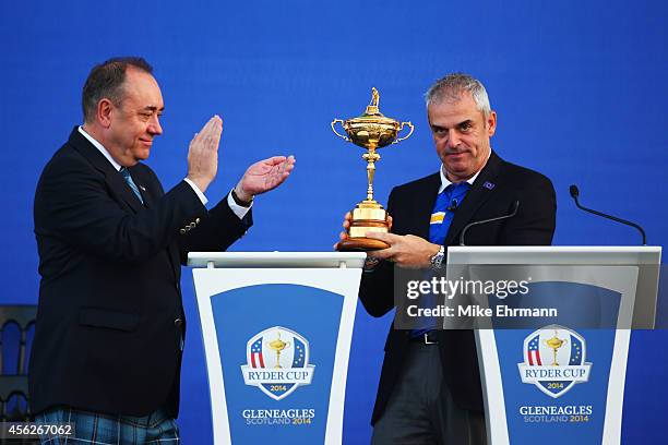 Europe team captain Paul McGinley is presented with the Ryder Cup trophy by Alex Salmond, First Minister of Scotland after the Singles Matches of the...