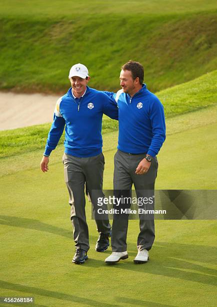 Rory McIlroy and Graeme McDowell of Europe celebrate winning the Ryder Cup after Jamie Donaldson of Europe defeated Keegan Bradley of the United...