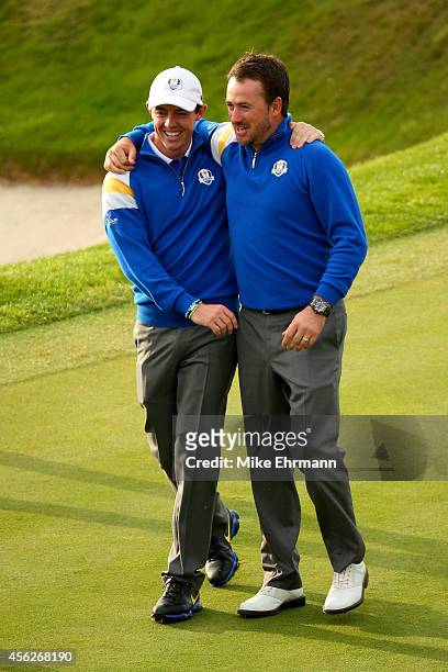 Rory McIlroy and Graeme McDowell of Europe celebrate winning the Ryder Cup after Jamie Donaldson of Europe defeated Keegan Bradley of the United...