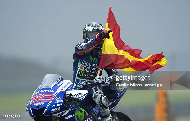 Jorge Lorenzo of Spain and Movistar Yamaha MotoGP celebrates with the flag of Spain after winning the MotoGP of Spain at Motorland Aragon Circuit on...