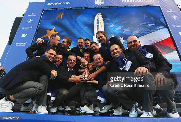 Europe team captain Paul McGinley poses with the Ryder Cup trophy and his team after the Singles Matches of the 2014 Ryder Cup on the PGA Centenary...