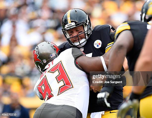 Ben Roethlisberger of the Pittsburgh Steelers is sacked by Gerald McCoy of the Tampa Bay Buccaneers during the first quarter at Heinz Field on...