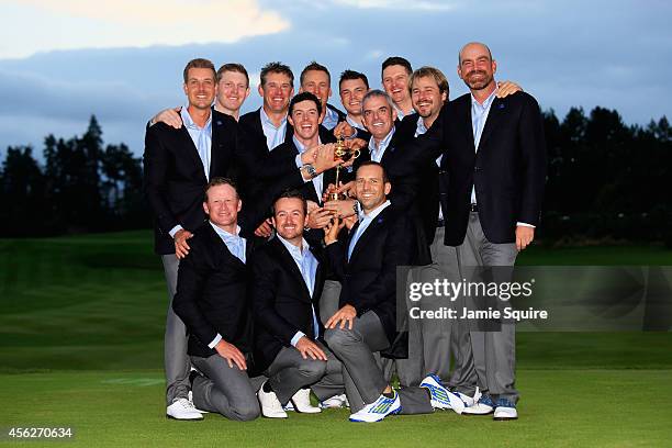 Europe team captain Paul McGinley poses with the Ryder Cup trophy and his team after the Singles Matches of the 2014 Ryder Cup on the PGA Centenary...
