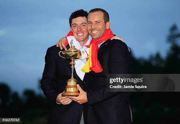 Rory McIlroy and Sergio Garcia of Europe pose with the Ryder Cup trophy after the Singles Matches of the 2014 Ryder Cup on the PGA Centenary course...