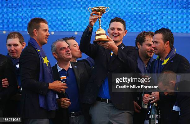 Justin Rose of Europe poses with the Ryder Cup trophy after the Singles Matches of the 2014 Ryder Cup on the PGA Centenary course at the Gleneagles...