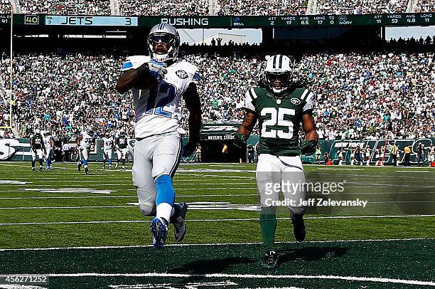 Jeremy Ross of the Detroit Lions scores a 59-yard touchdown in the in the second quarter as Calvin Pryor of the New York Jets looks on at MetLife...