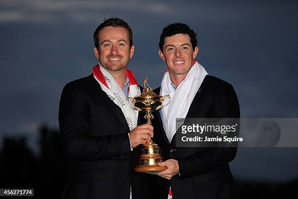 Graeme McDowell and Rory McIlroy of Europe pose with the Ryder Cup trophy after the Singles Matches of the 2014 Ryder Cup on the PGA Centenary course...