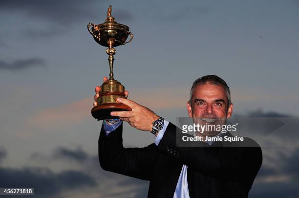 Europe team captain Paul McGinley lifts the Ryder Cup trophy after the Singles Matches of the 2014 Ryder Cup on the PGA Centenary course at the...