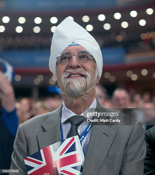 Delegate listens to Leader of the House of Commons, William Hague, address delegates at the Conservative party conference for the last time in his...